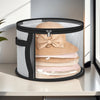 A black storage box with a clear window holds several beige and pink knitted hats.