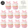 A set of pink cupcake toppers featuring white frosting and pink bows for parties.