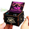 A carved wooden music box featuring a Jurassic Park theme with a dark purple and green design.