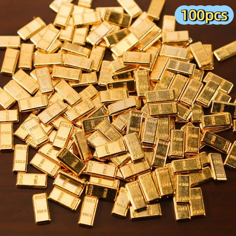 A pile of small, rectangular gold-colored metal prosperity decorations.