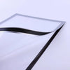 A close-up view of a magnetic poster display frame with a silver and black curved edge.