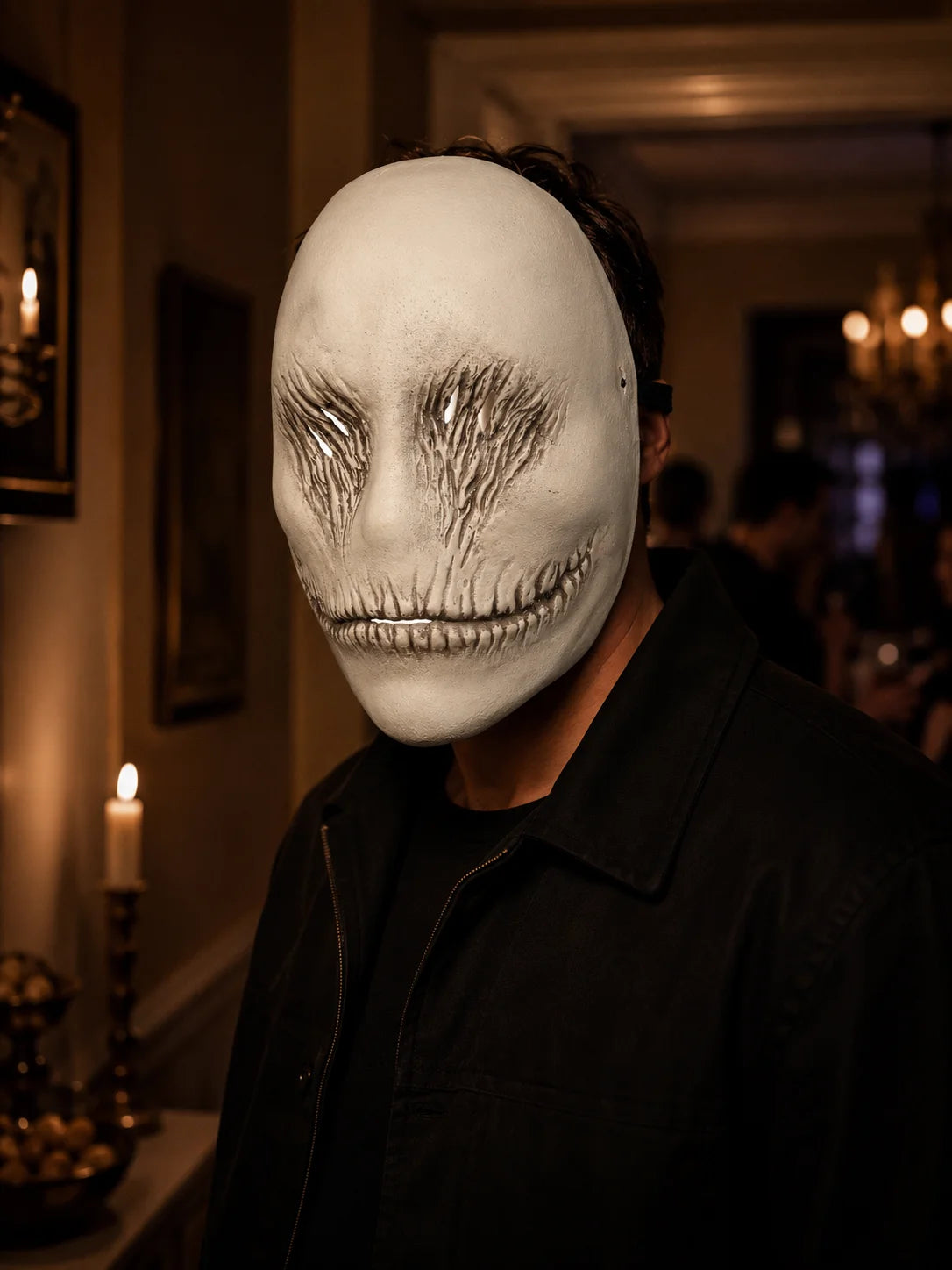 A person wearing a sculpted white ghost face mask in an indoor setting.