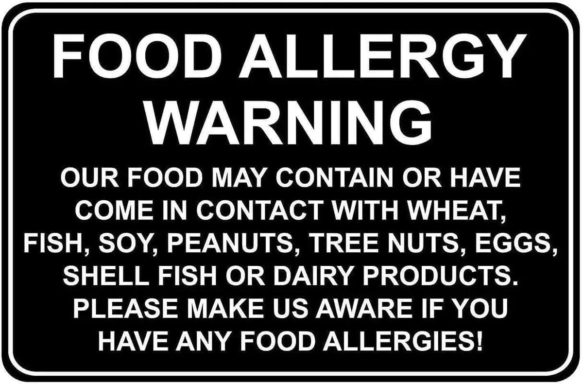 A black sign with white text warning about food allergies, listing potential allergens like wheat, fish, soy, peanuts, tree n