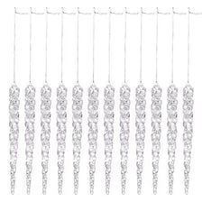 A set of twelve clear acrylic icicle Christmas tree ornaments hanging by thin strings.