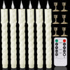 A set of white fluted LED taper candles with gold-colored remote controls for timer and light functions.