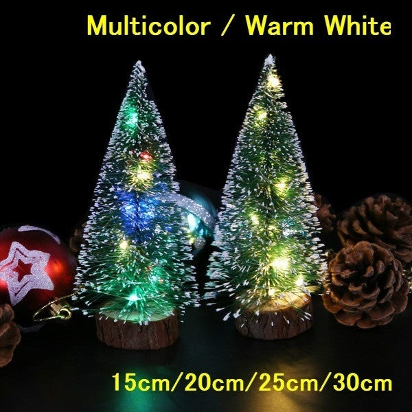 Four miniature LED Christmas trees of varying heights and colors displayed against a black background.