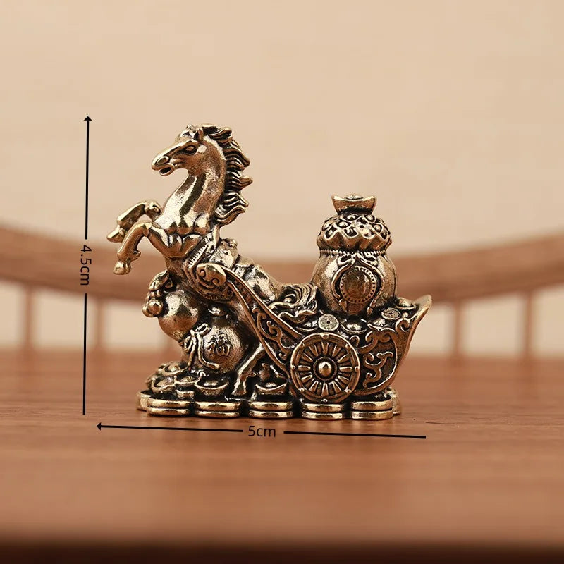 A solid copper figurine of a horse for prosperity and positive energy, displayed on a wooden surface.