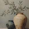 A ceramic vase holds a branch of olive leaves against a light gray background.
