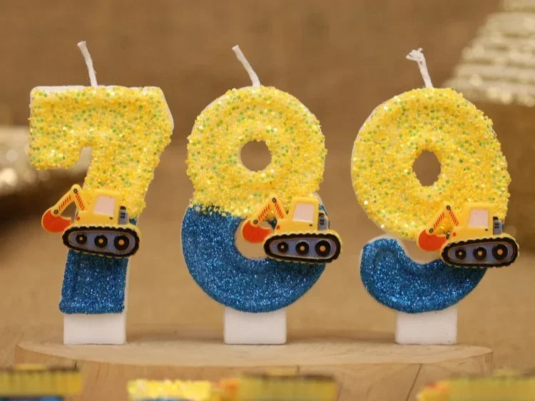 Three yellow construction excavator birthday cake candles with blue glitter bases