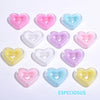 A collection of multi-color heart-shaped acrylic charms in pink, purple, and blue.