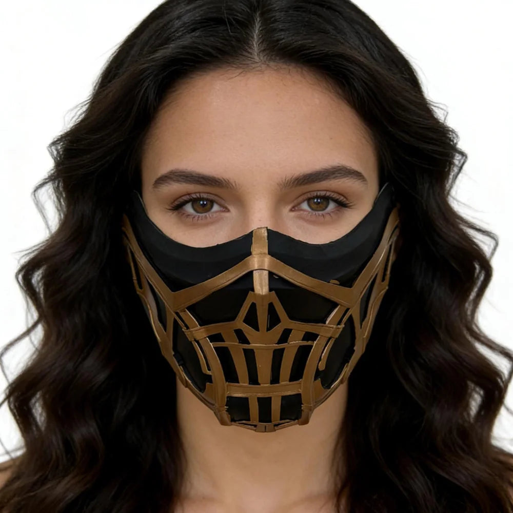 A woman wearing a black and gold Mortal Kombat Sub-Zero and Scorpion cosplay half-face mask.