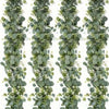 A vertical garland of silvery-green eucalyptus leaves and small white flowers for wedding or home decor.