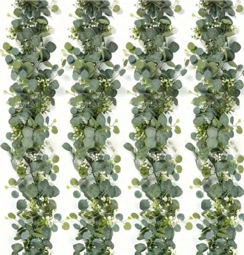 A vertical garland of silvery-green eucalyptus leaves and small white flowers for wedding or home decor.