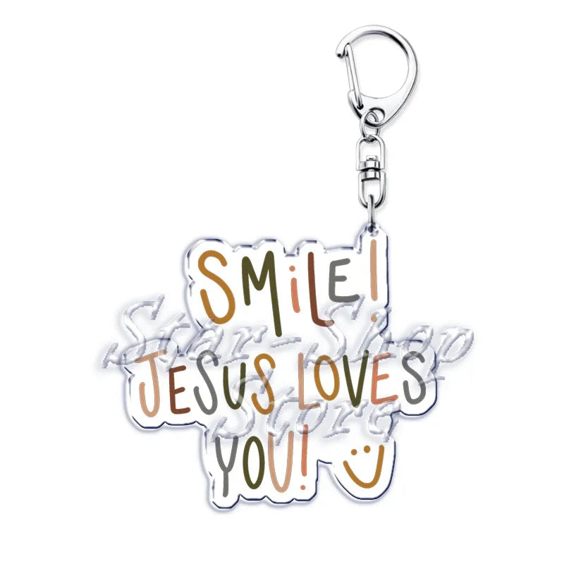 Klares Acryl-Anhänger mit dem Text Smile Jesus Loves You!