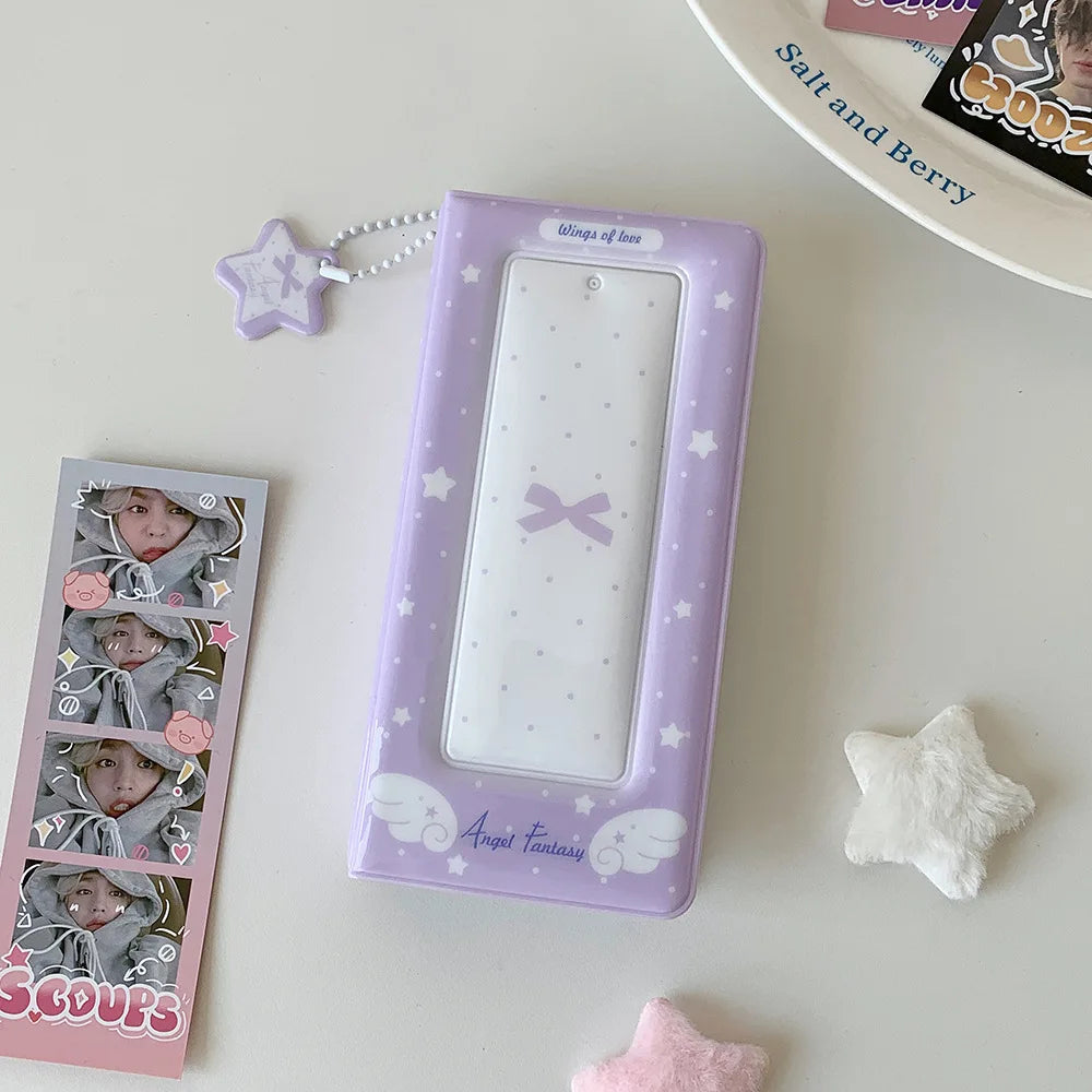 A purple photo booth album with a clear window and pink accents sits on a white surface.