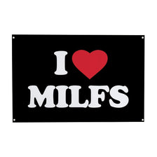 A black rectangular sign with white text that reads I ❤️ MILFS