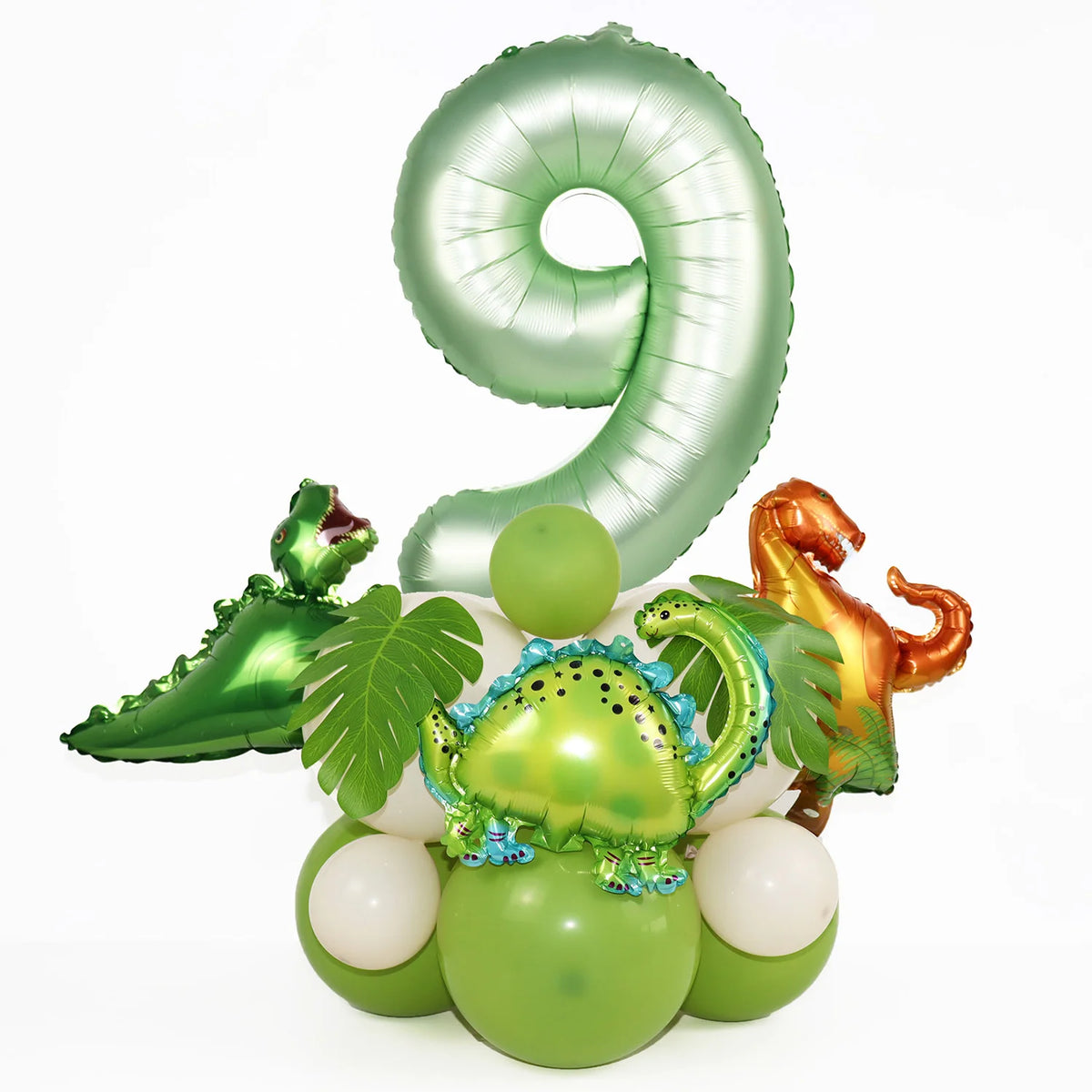 A green foil balloon shaped like the number 9 is displayed alongside small dinosaur-themed balloons.