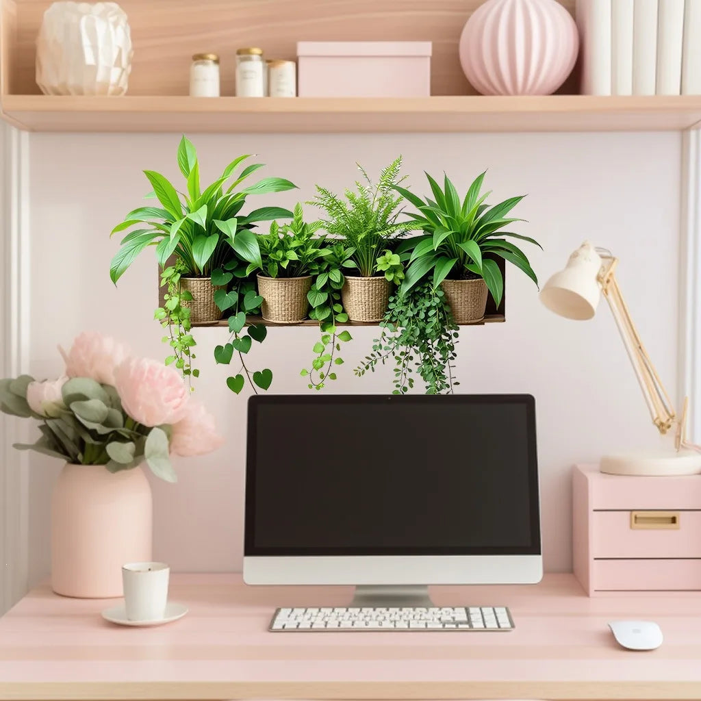 A desk setup featuring a computer monitor and potted green plants on a wooden shelf.