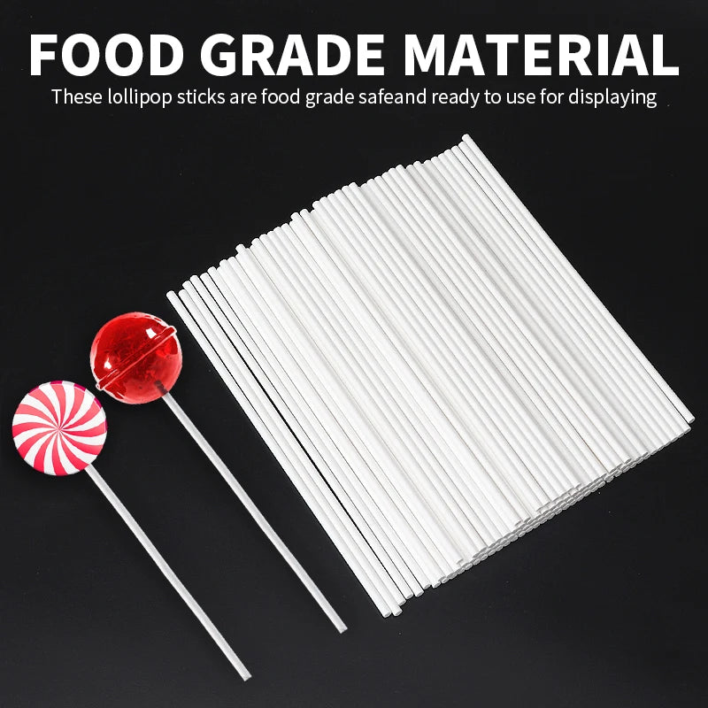 A pile of white food grade lollipop sticks with a red and white swirl lollipop stick displayed on a dark background.