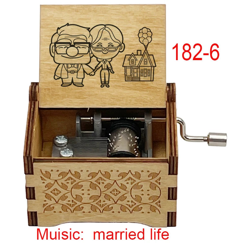 A wooden music box with a lid featuring two figures and an illustration of a house, designed for married life.