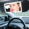 A car sun visor vanity mirror with an LED light showing a woman's face.