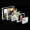 A collection of clear acrylic magnetic photo frames displayed on a dark surface.