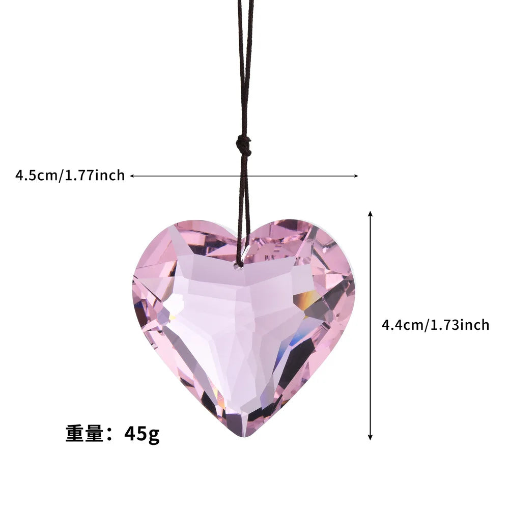 Pink crystal heart prism sun catcher pendant hanging by a black cord