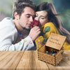 A couple tenderly shares a rose near a vintage hand-cranked wooden music box labeled Can't Help Falling in Love.