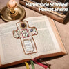 A handmade stitched pocket shrine featuring a cross design on an open book with text.
