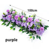 A lush purple floral arrangement featuring various artificial flowers and greenery.
