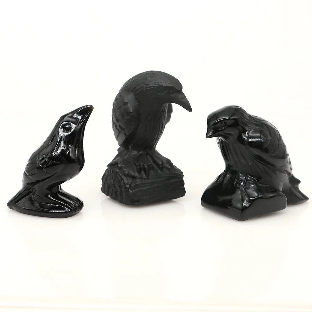 Hand-carved black obsidian raven figurine with a curved posture