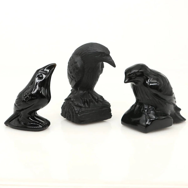 Hand-carved black obsidian raven figurine with a curved posture