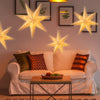 Elegant hollow star pendant light decor hanging above a sofa.