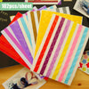 A colorful stack of 102 photo corner protectors in various stripes and solid colors for scrapbooking projects.