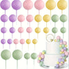 A set of 20 mini foam ball cake toppers in shades of purple, pink, and yellow arranged vertically.