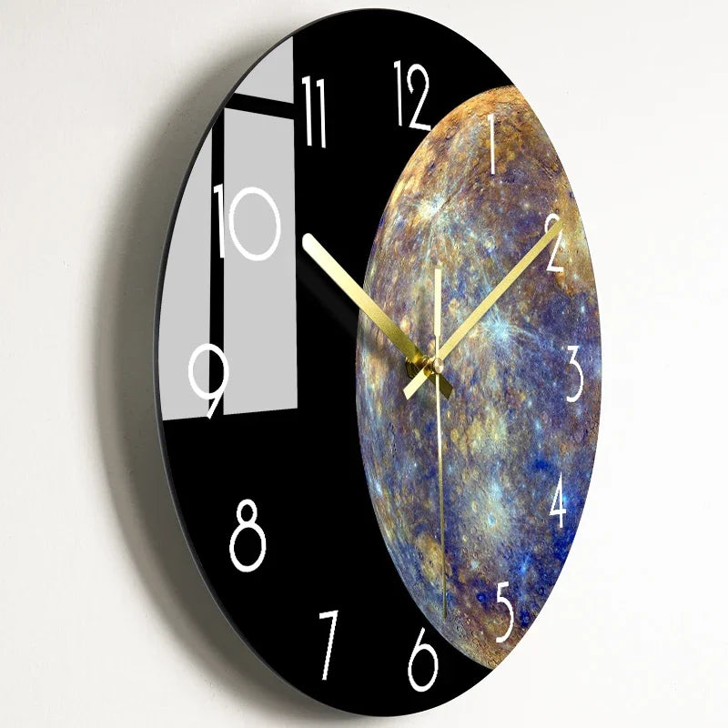 A black round wall clock featuring a celestial design on the face and a modern glass panel on the left.