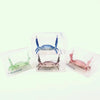 Clear plastic crab-shaped desk organizer with a pen and phone holder