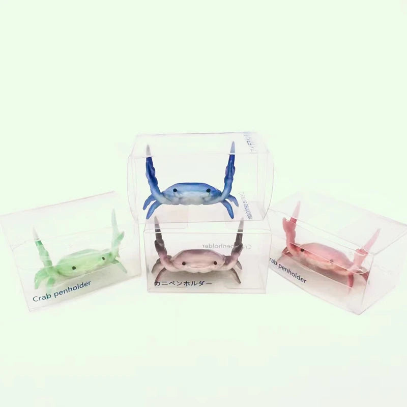 Clear plastic crab-shaped desk organizer with a pen and phone holder
