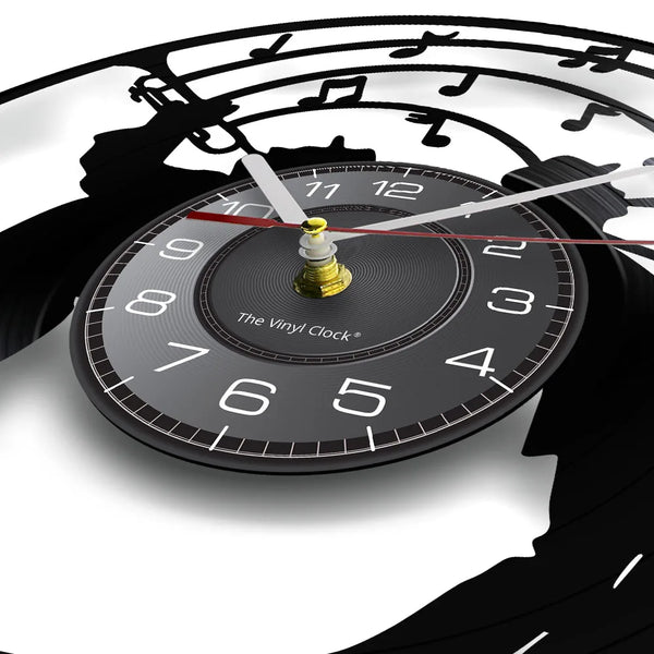 A close-up of a vintage vinyl record wall clock showing the face and markings.