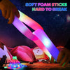 A hand holds a bundle of soft foam glow sticks with various light modes against a night sky backdrop.