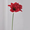 A vibrant red artificial clivia amaryllis flower on a green stem.