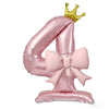 A pink foil balloon shaped like the number four with a gold crown topper