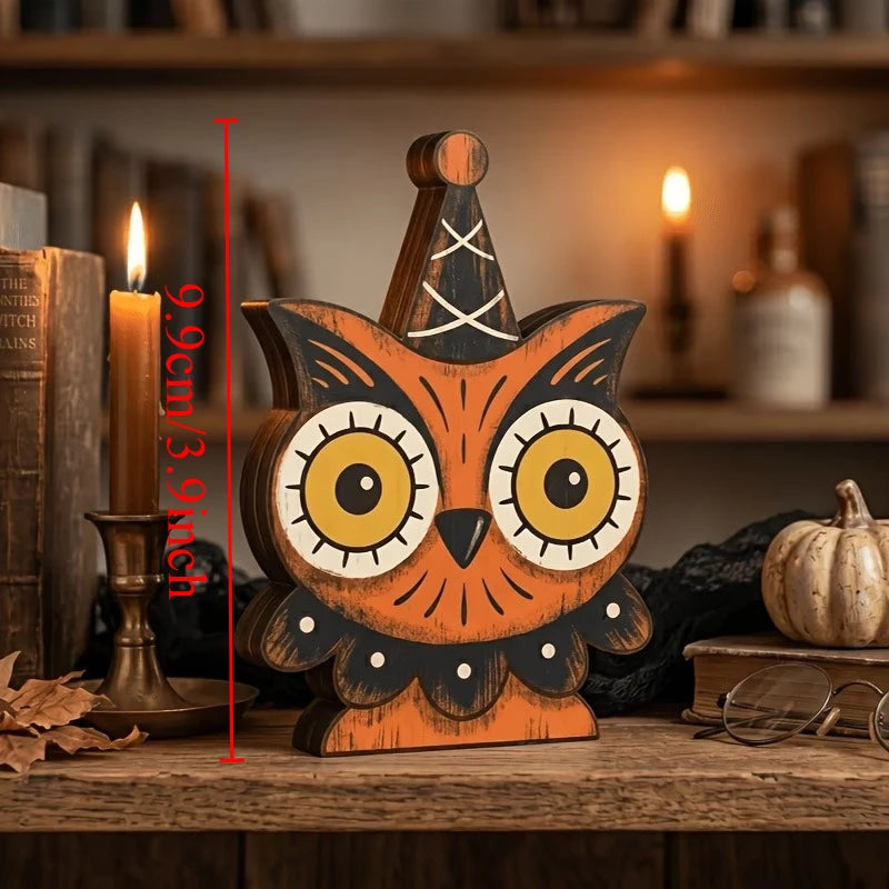 A wooden owl decoration with large eyes and a carved candle on a rustic wooden surface.