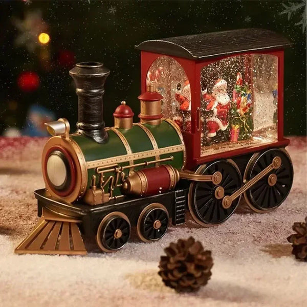 A miniature Christmas train with a red cabin and green body, featuring LED lights and a water-filled crystal ball.
