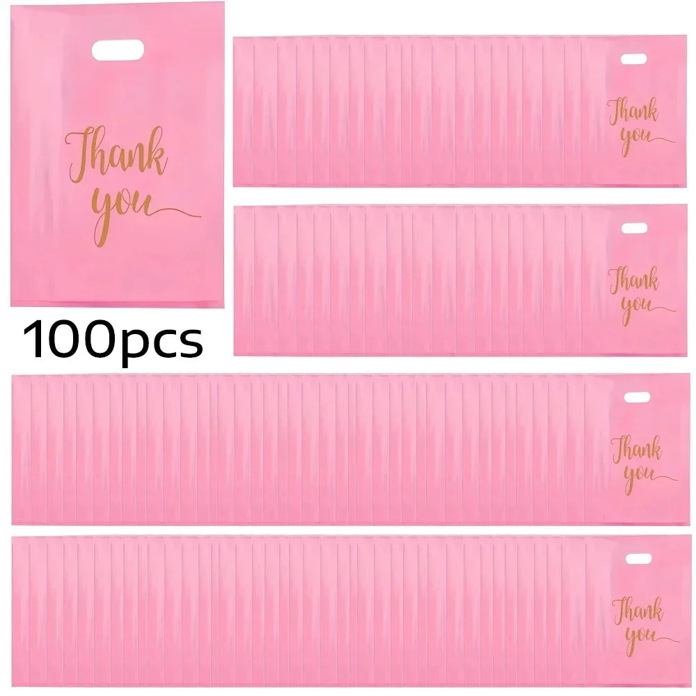A pack of 100 pink clear plastic gift bags with thank you text printed on them.
