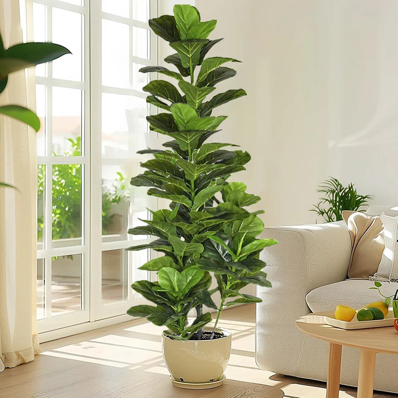 A tall artificial fiddle leaf fig tree in a white pot stands near a glass door with bright natural light.
