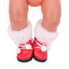 A pair of red boots with white fluffy trim and white laces for a Christmas doll outfit set