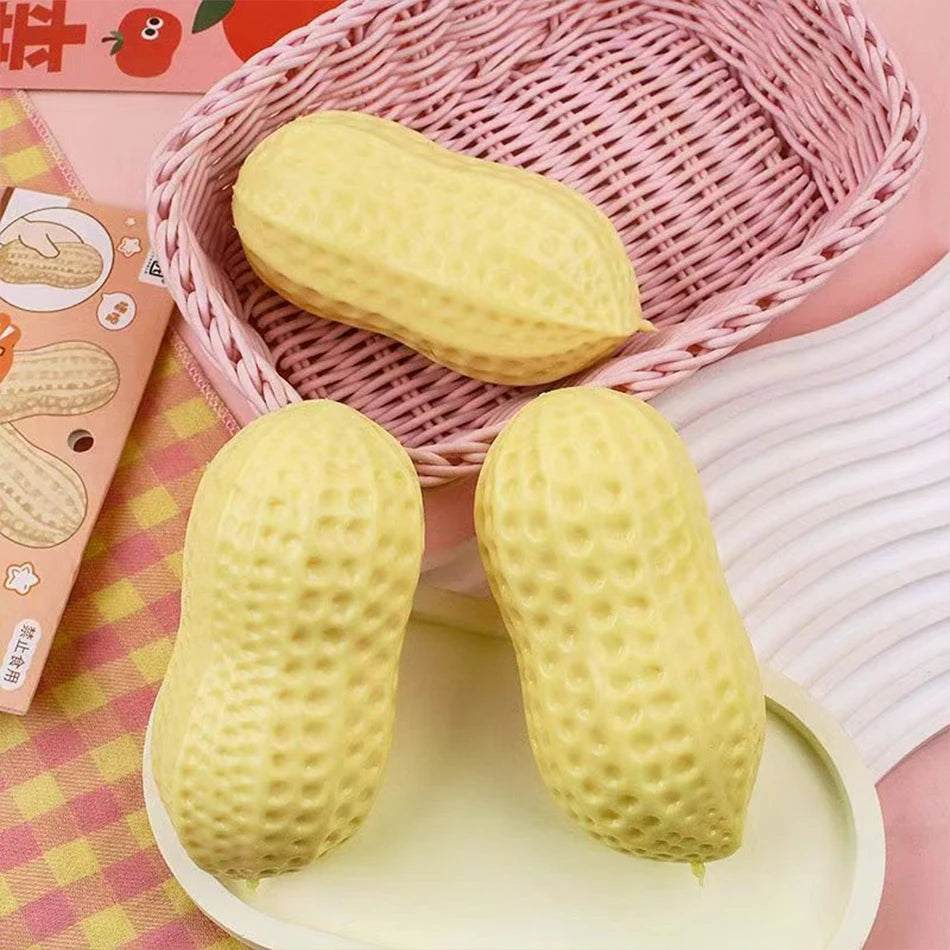 A yellow peanut-shaped stress ball is shown in a pink woven basket and on a light green tray.