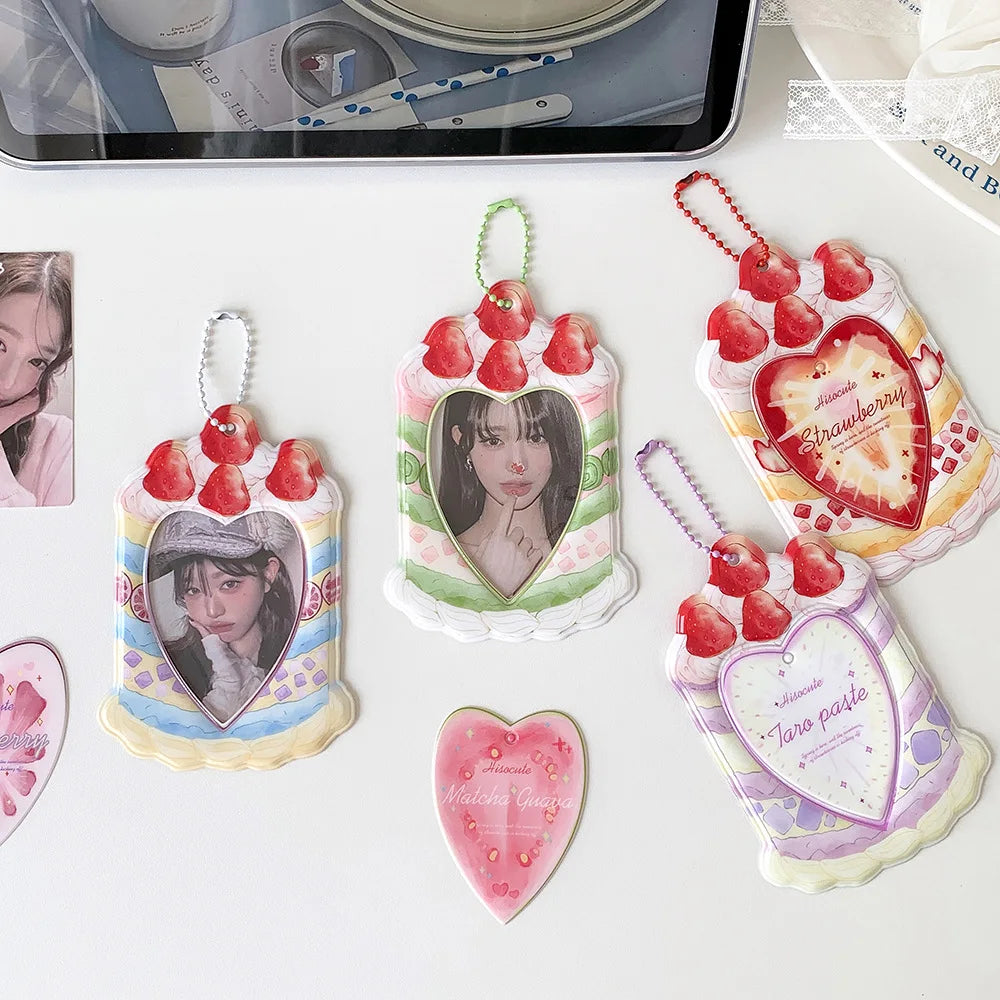A collection of strawberry-themed bag keychains, card holders, and heart-shaped charms featuring pink, red, and green colors.