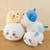 A collection of Chiikawa Hachiware plush toys in white and blue colors sitting on a wooden surface.